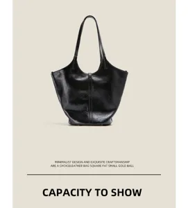 Detailed view of the black soft leather tote bag, showcasing its large capacity and crinkled texture.
