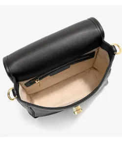 Black leather shoulder bag detail showing interior lining, gold hardware and zip pocket.