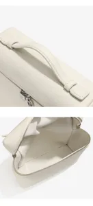 Gros plan détaillé du sac à dos en cuir blanc montrant la texture, la poignée et la fermeture.