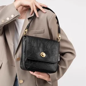 Elegant black crumpled leather shoulder bag for women, vintage underarm tote with gold lock.