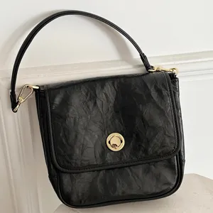 Black genuine leather shoulder underarm bag for women, retro crinkled design with metal lock.