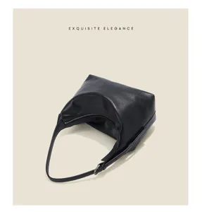 Detailed view of black genuine leather hobo shoulder bag showing texture and craftsmanship.