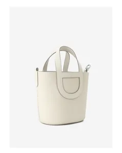 Detailed view of the off-white leather bucket bag, showing exquisite handle craftsmanship.