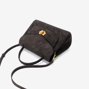 Retro brown leather Kelly shoulder bag, elegant top handle design with chic gold hardware.