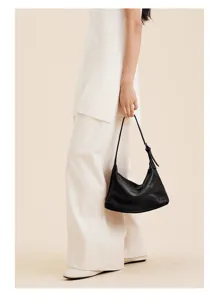 Detailed view of women genuine leather hobo underarm shoulder bag in classic black color.