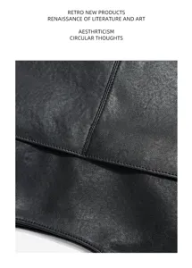 Leather bag detail shot showcasing fine stitching texture and premium black cowhide quality.