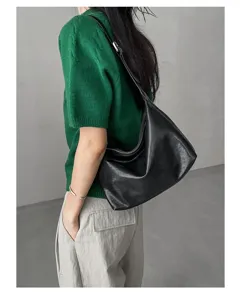 Detailed view of women genuine leather black hobo shoulder bag casual underarm handbag.