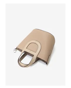 Close-up detail of the premium leather bucket handbag featuring unique handle design.