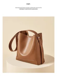 Close-up detail of genuine leather bucket bag, showing premium texture and stitching.