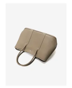Detailed view of taupe leather tote bag, showing fine texture, double handles and neat stitching.