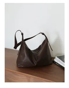 Brown leather hobo shoulder bag detailed view, minimalist commuter tote purse for women.