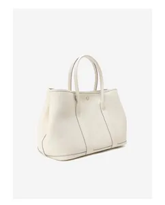 Leather tote bag detail showing premium cowhide texture, durable handles and clean stitching.