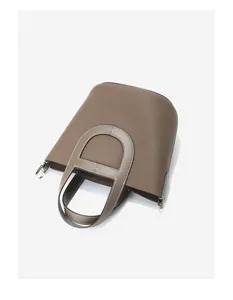 Detailed view of the brown Togo leather bucket bag, showcasing premium texture and elegant handle.
