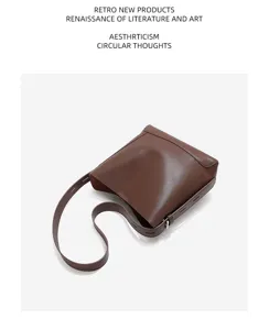 Detailed view of the brown leather bucket bag showcasing premium texture and adjustable strap.