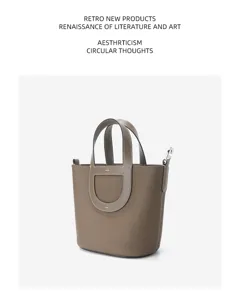 Togo leather bucket bag for women, stylish top handle handbag with spacious interior design.