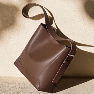 Brown genuine leather bucket bag for women, large capacity shoulder and crossbody bag for daily work.
