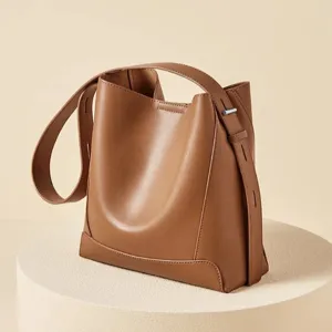 Genuine leather bucket bag for women, large capacity stylish tote bag for daily commute.