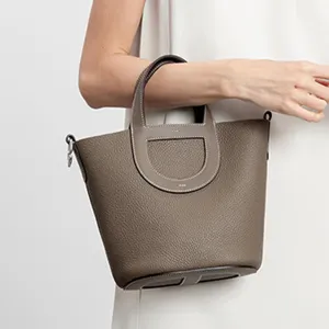 Premium leather bucket bag with D-handle design, stylish large capacity tote handbag for women.