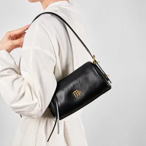Black genuine leather baguette shoulder bag for women, stylish cylinder underarm bag.