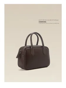 Brown leather Boston bag detail, compact zipper handbag, premium commuter everyday style.