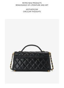 Detailed view of the black quilted leather handbag, featuring metallic chain strap and top handle.