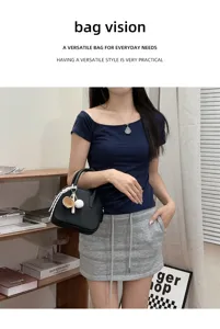 Womens fashion black bowling bag stylish crossbody handbag with cute pendant for daily use.