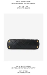 Detailed bottom view of a black quilted leather women shoulder chain bag with gold metal feet.