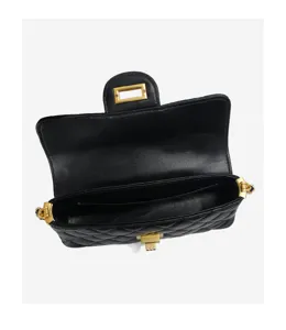 Close up of black quilted leather shoulder bag with gold tone hardware and clasp detail.
