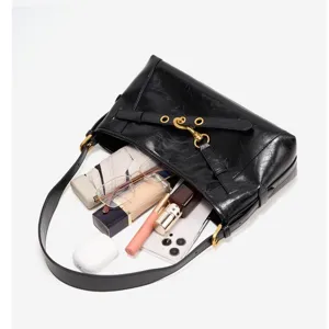 Close-up detail showcasing the spacious interior capacity and sleek black leather bag.