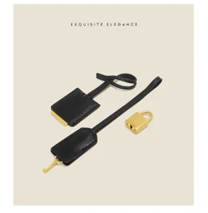 Black leather clochette lock and key set handbag accessory detail view for stylish bags.