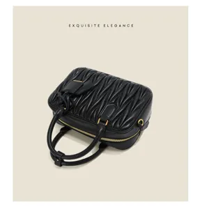 Close-up detail of the black lambskin quilted mini bowling handbag featuring gold tone hardware.