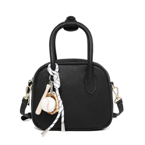 Women black bowling shoulder bag with baseball charm, stylish PU leather crossbody handbag.