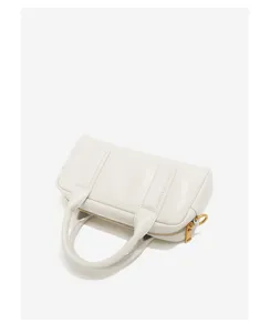 Leather boston bag detail view showing premium texture, zipper closure and top handles.