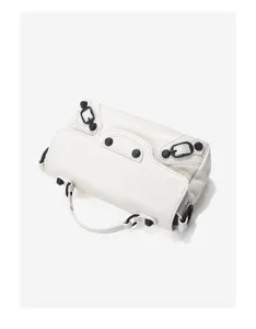 White leather mini motorcycle bag detail showing black studs and hardware buckle features.