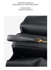 Detailed shot of the black genuine leather Boston bag zipper and handle texture design.