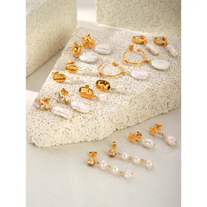 Detailed shot of trendy gold-plated stainless steel earrings featuring irregular baroque pearls.