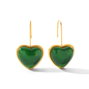 Detailed close-up view of the green heart resin earrings showcasing the glossy finish and gold frame.
