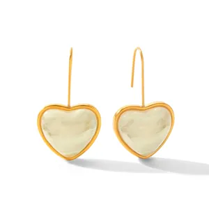 Gold-rimmed white marbled heart resin drop earrings, sleek fashion jewelry detail.