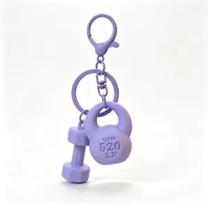 Mini fitness equipment keychain detail shot, purple kettlebell and dumbbell hanging ornament.