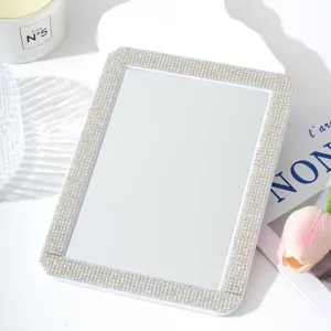 Detailed view of the rhinestone makeup mirror, showing exquisite crystals and clear glass.