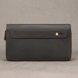 Detail view of vintage genuine leather men's clutch wallet with card slots and strap.