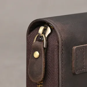Men's genuine leather wallet close-up, showing vintage brown cowhide texture, durable zipper.