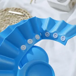 Blue adjustable baby shower cap with ear protection for safe and easy hair washing time.
