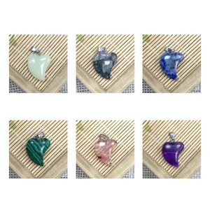 Natural stone heart pendant detail view showing various colors and textures with metal bail.