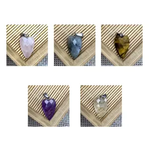 Detailed view of faceted heart crystal gemstone pendants, natural stone charms for DIY jewelry.