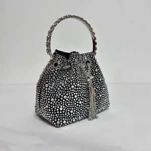 Black crystal rhinestone bucket bag with metal ring handle and glamorous tassel pendant.