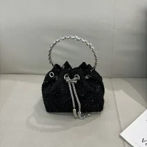 Black rhinestone bucket evening bag with silver metal round handle and chain drawstring detail.