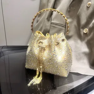 Sparkling rhinestone bucket bag with metal ring handle and chic tassel chain detail.