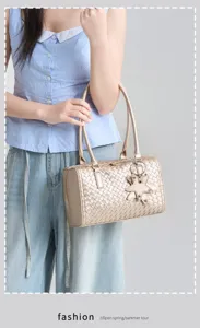 Golden woven shoulder bag for women, stylish commuting handbag with cute star charm design.