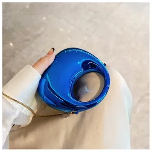 Glossy blue mini handbag with unique round hollow design and chic gold chain strap detail.